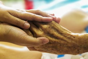 Nurse holding an elderly hand